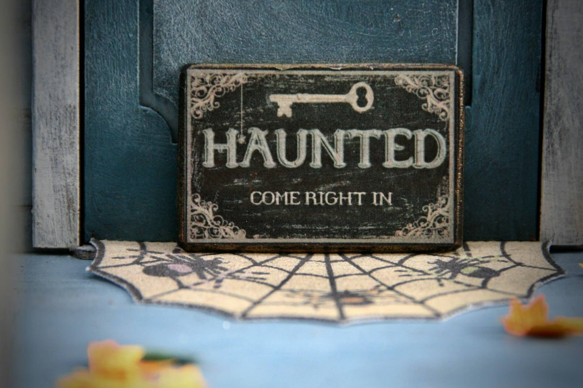 A doorstep with haunted house decorations