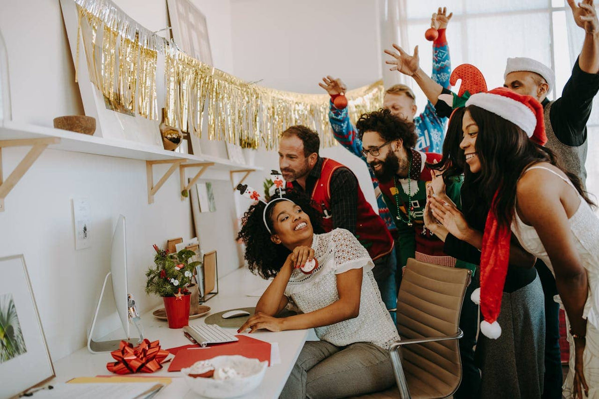 A group of people celebrating the holiday season in an office