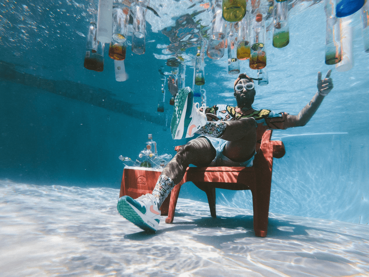 man sitting on chair under water