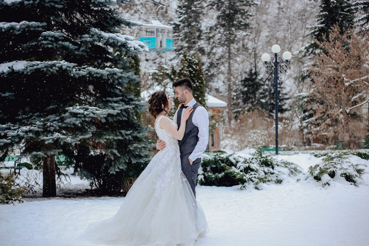A couple is taking wedding photos in the snow
