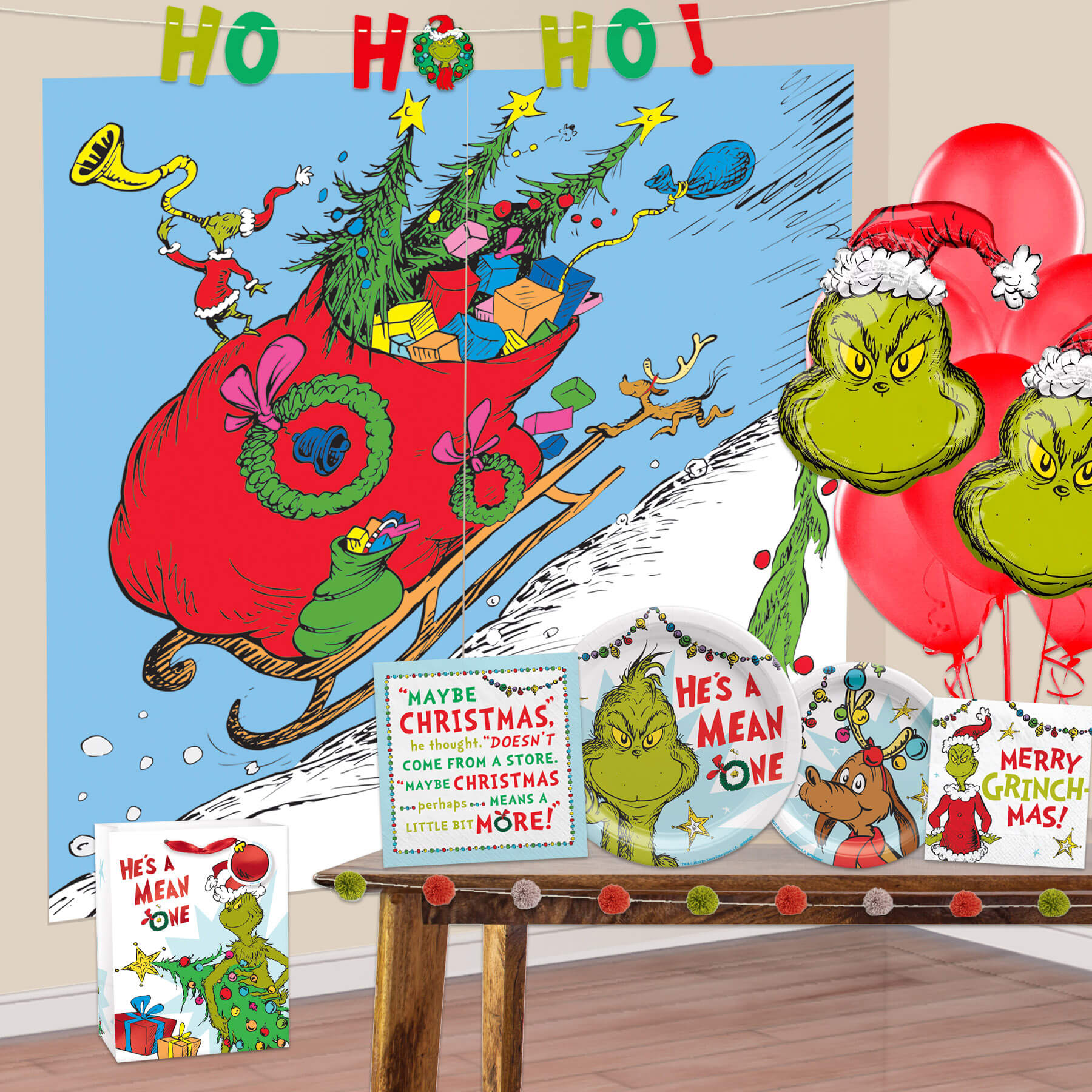 the grinch wall decorations with plates, napkins, and balloons